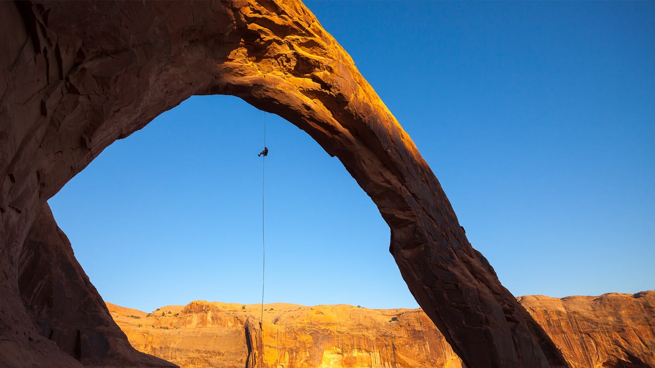 A man rappels off Corona Arch near Moab, Utah, United States (© Grant Ordelheide/TANDEM Stills + Motion)